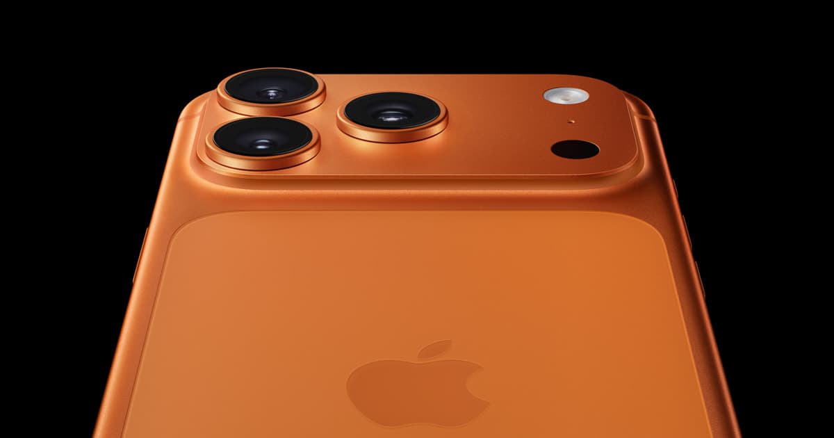 iPhone 17 Pro in Cosmic Orange, close-up on the triple rear camera module.
